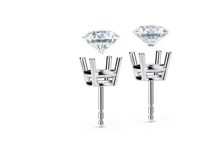 Diamonds being set into four-prong earring settings