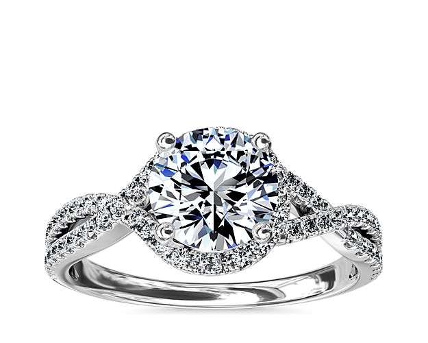 Capture your lasting love with this stunning 14k white gold engagement ring that showcases an elegant drape of pavé-set diamonds around your center stone and along the twisting shank for a captivating look.