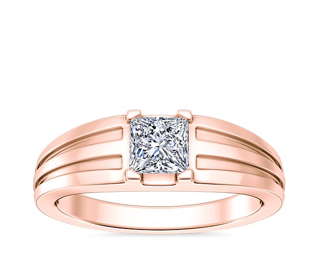 Love shines brilliantly from this engagement ring featuring an elegant center setting that  supports princess (prince), emerald-cut, and radiant-cut diamonds. The lustrous 18k rose gold design features beautifully tapered and grooved stylings along the band.