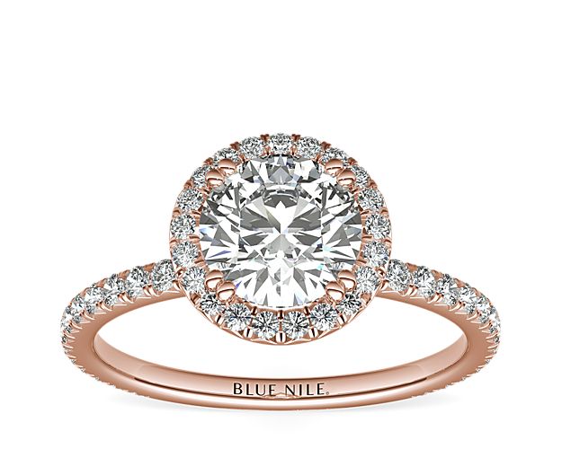 Beautifully crafted, this Blue Nile Studio 18k rose gold engagement ring features a french pavé-set diamond halo that encompasses the center diamond of your choice.