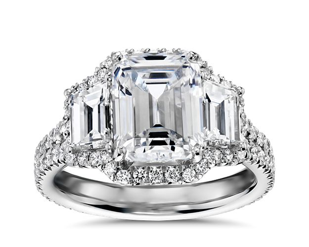 Brilliance defined. A pair of trapezoid side diamonds frame the emerald-cut center stone of your choice in this timeless and breathtaking platinum engagement ring.