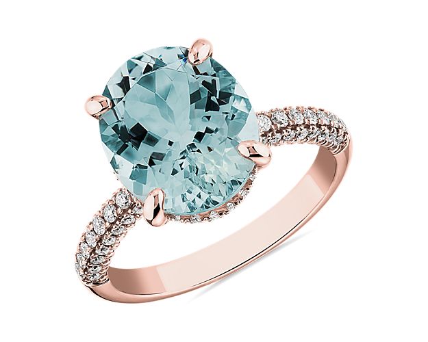 This vibrant blue aquamarine makes a bold statement in this ring. Accented with two rows of round pavé diamonds and set in 14k rose gold, this is a stunning piece.