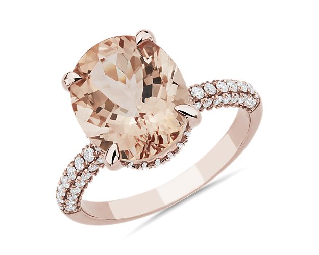 Crafted in 14k rose gold, this ring features a stunning morganite set atop a hidden halo.  Three rows of diamonds along the band ensures sparkle from every angle.