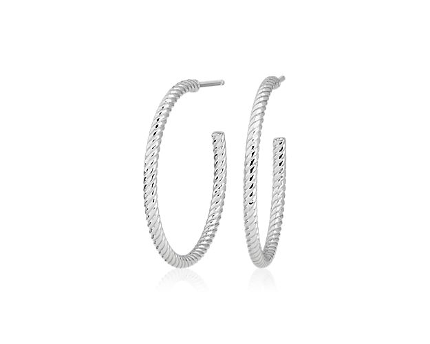 A perfect everyday size, the patterned surface of these medium platinum hoop catches the light for just a glint of shine at the ear. The classic hoop size of these earrings makes them perfect for anyone.