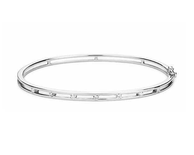 Delicately set in 14k white gold, this bangle has seven stationed diamonds for a little touch of elegance.