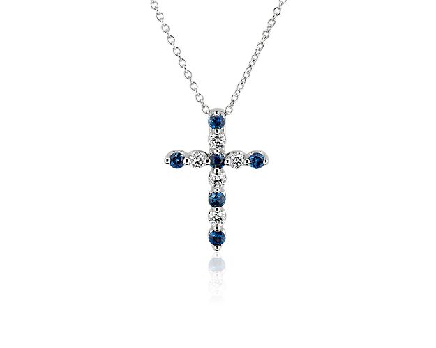 Express your faith in breath-taking style with this classic cross pendant adorned with brilliant blue sapphires that alternate with sparkling diamonds. The gleaming 14k white gold design promises enduring quality and a luxurious look.