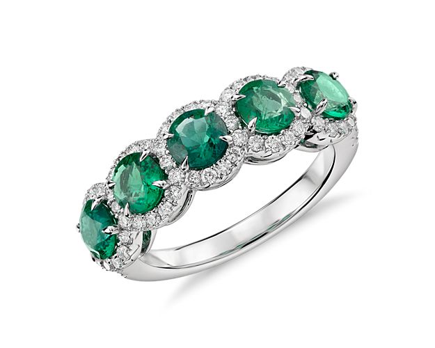 Elegant in design, this ring features vivid green emerald gemstones surrounded by a halo of brilliant diamonds framed in 18k white gold.  Due to their delicate nature, emeralds require special care.  Removal of this ring when active will maintain beauty and ensure every piece endures for years to come.