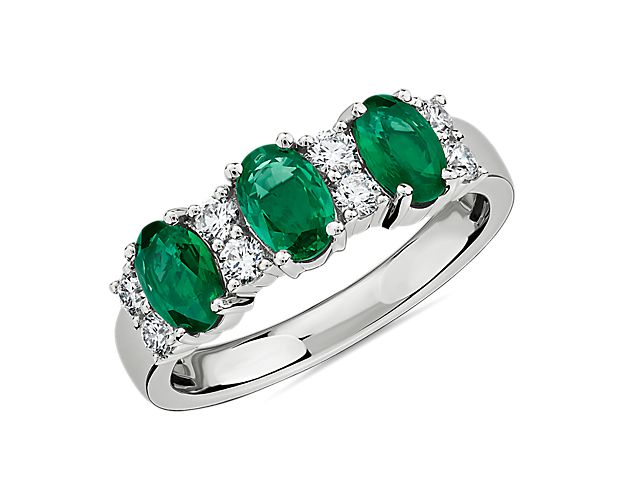 Elegant in design, this ring features three vivid emeralds accented with rows of brilliant diamonds set in 14k white gold.