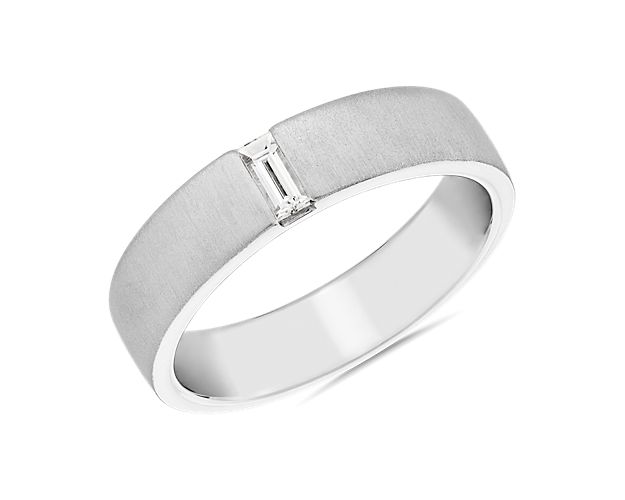 From Zac Posen, this solid platinum band is finished with brushed texture for a modern twist. Juxtaposed by a brilliant baguette cut diamond in a north-south setting, the ring has a touch of sparkle for that little something special.