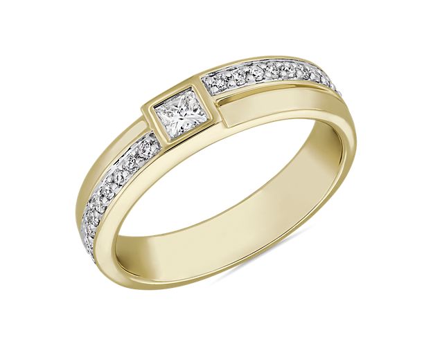 Modern luxury and universal elegance define the glamourous look of this 14k yellow gold ring from ZAC by Zac Posen. A string of diamonds encircles the band offset by a center bezel-set diamond.