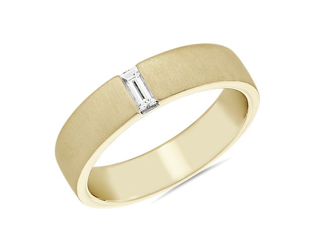 Celebrate the love of your life with this striking wedding band from Zac Posen. Warm 14k yellow gold is accented by a north-south baguette diamond set into a brushed texture ring.