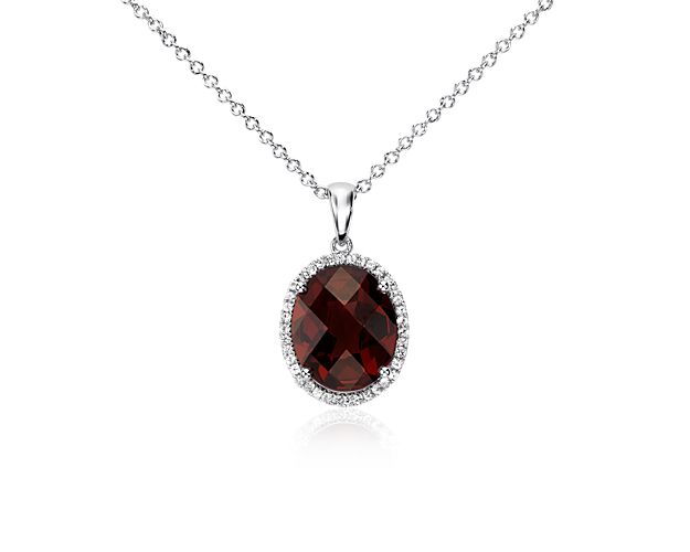 Brilliant and color-rich, this gemstone pendant features a halo oval garnet framed by round white sapphires and set in sterling silver with a matching cable chain necklace.