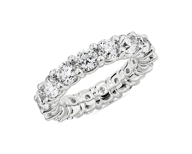 A stunning 5 ct. tw. of round-cut diamonds lend their vivid brilliance to this eternity ring, making it a sparkling symbol of love. It is crafted from luxurious platinum for a rich gleam and exceptional quality that lasts.